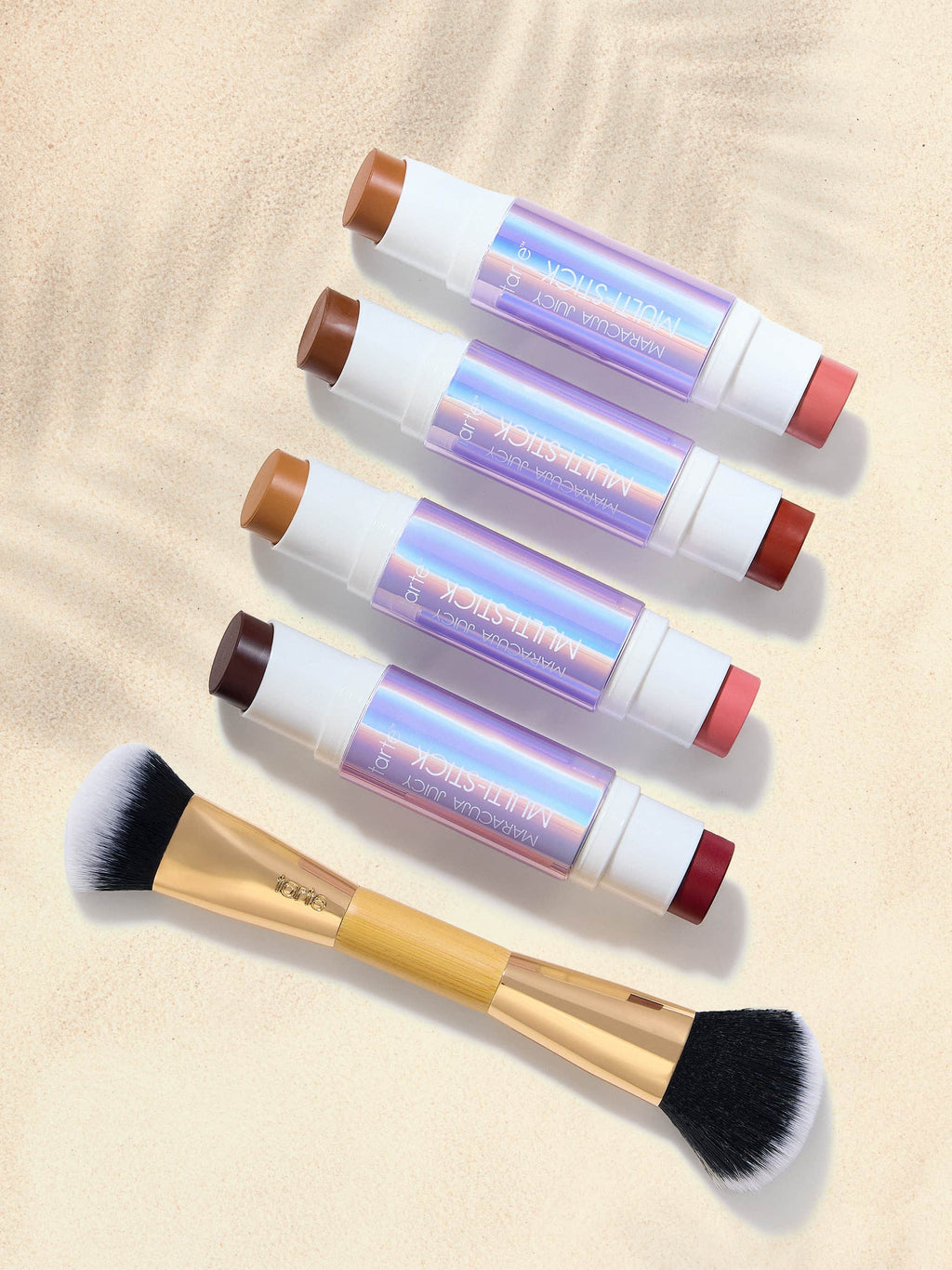 Set of double ended multi stick with colorful handles on a beige background