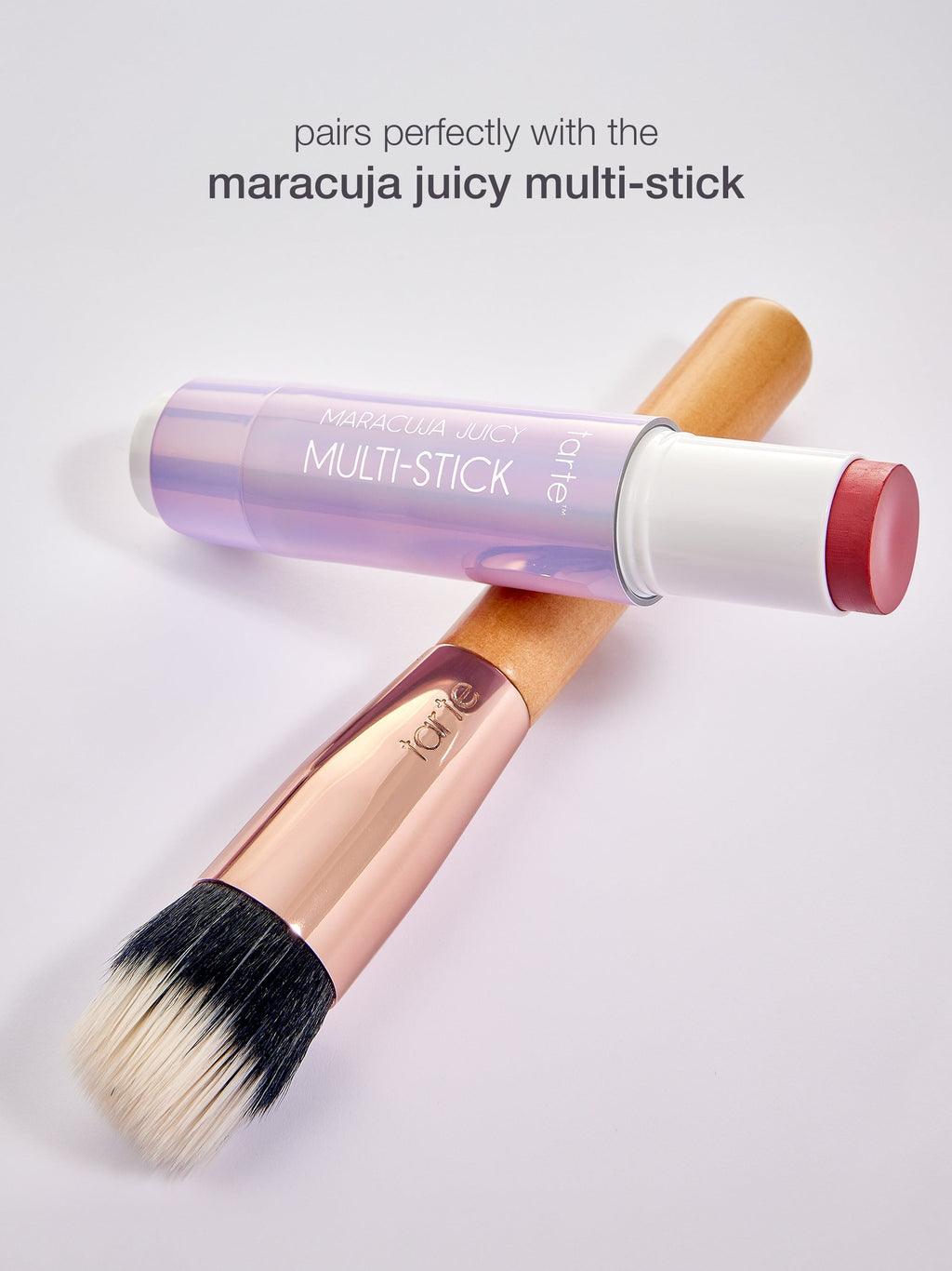Makeup stick with brush on a light gray background
