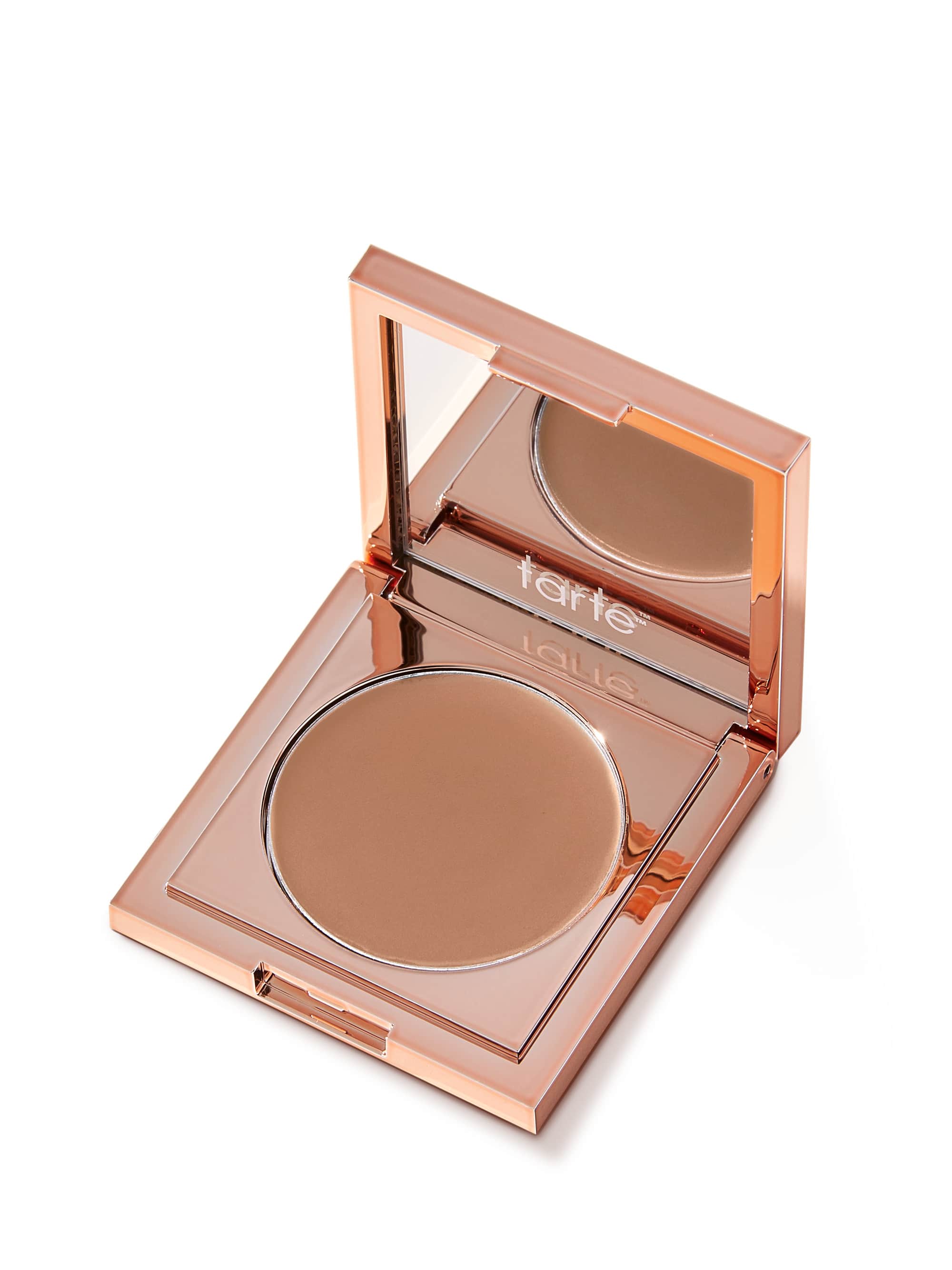 Open compact powder with 'tarte' branding on a white background