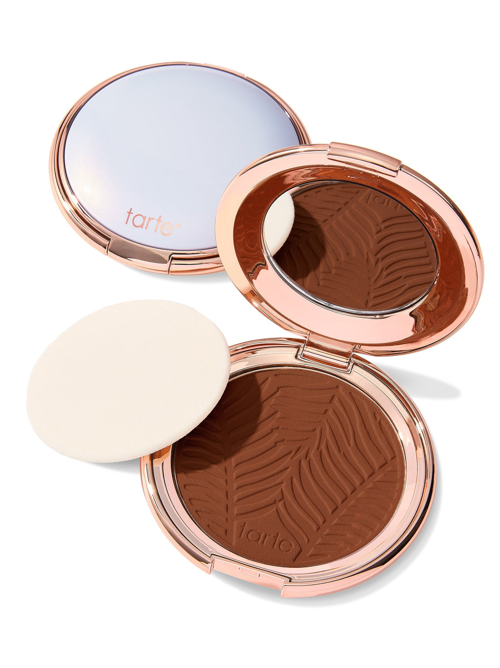 Compact powder with zebra pattern and 'tarte' branding on a white background