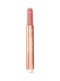A slim rose-gold Tarte lip balm stick stands vertically, cap removed to reveal a rosy balm tip against a plain white background. Text: tarte MARACUJA JUICY LIP PLUMP